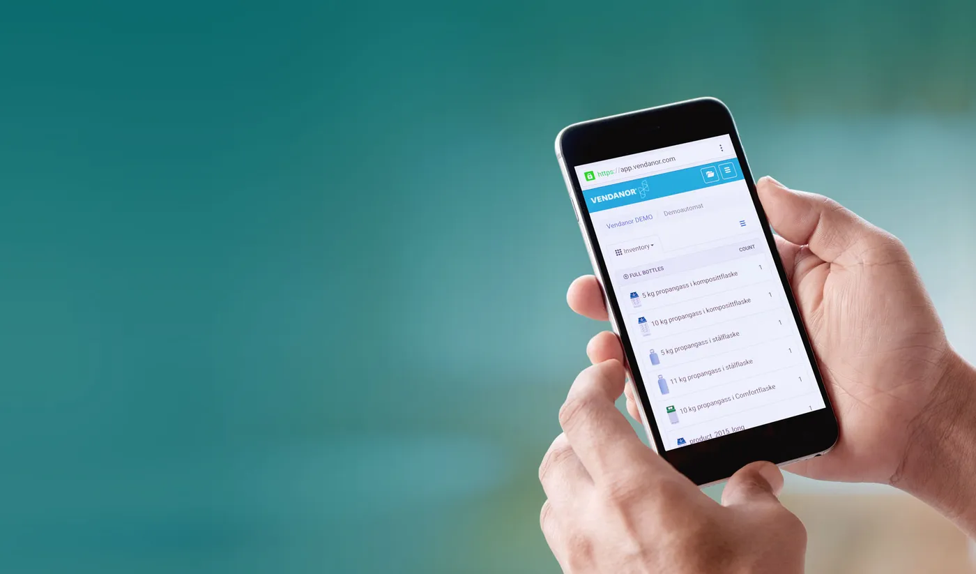 Two hands hold a smartphone showing the Vendanor Connect app with a propane cylinder inventory list.