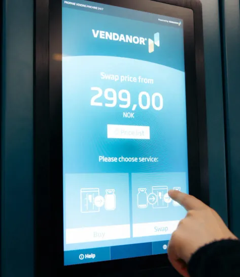 Customer using the Vendanor Propane Vending Machine touchscreen to choose buy or swap service.