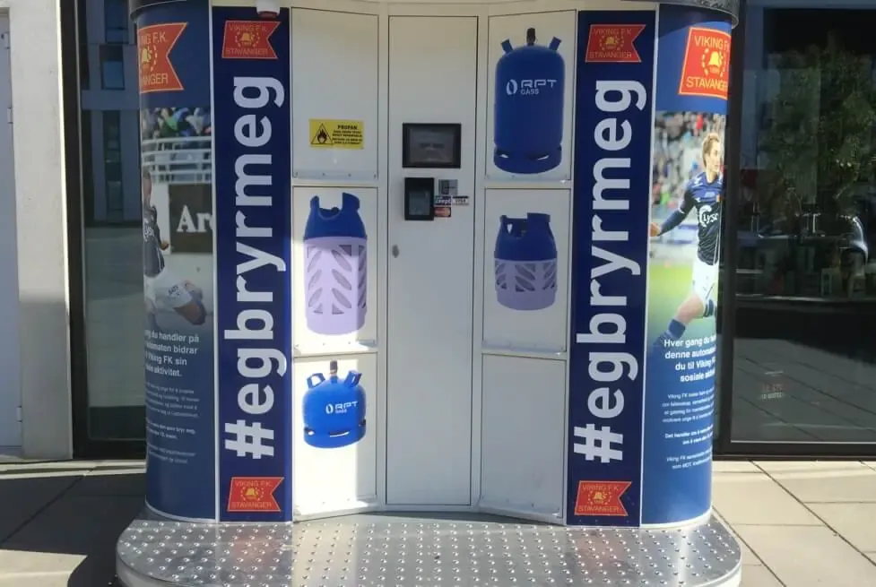 Vendanor Propane Vending Machine wrapped in blue Viking FK #egbryrmeg campaign branding, dispensing propane cylinders outdoors.